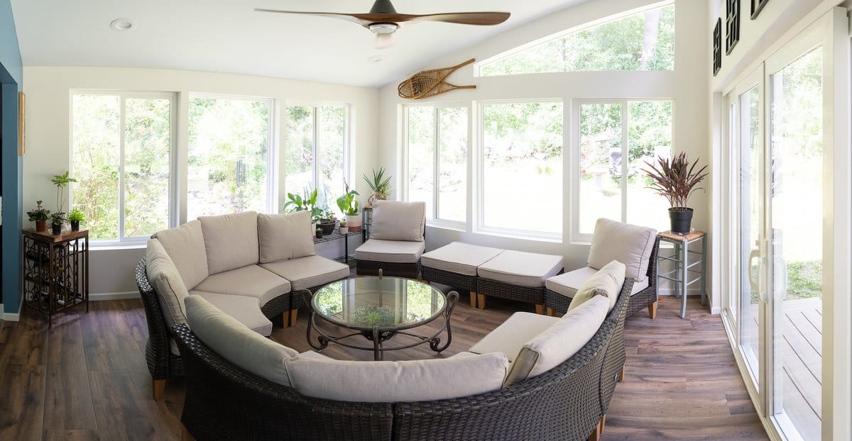 Four-season sunroom addition with floor-to-ceiling windows