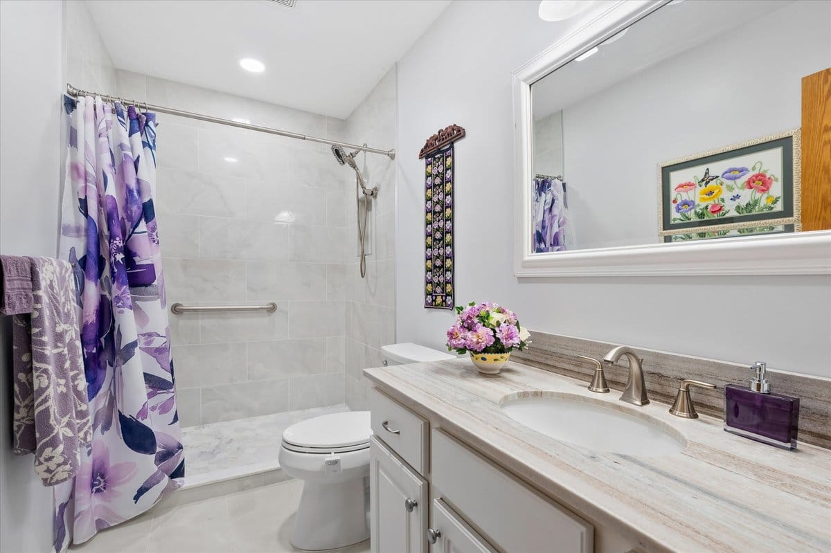 Marble tile shower with quartz vanity