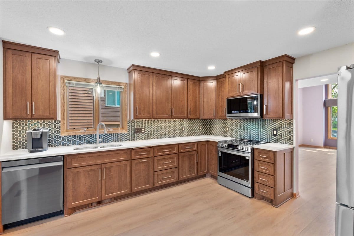 Custom walnut cabinetry with hex tile backsplash